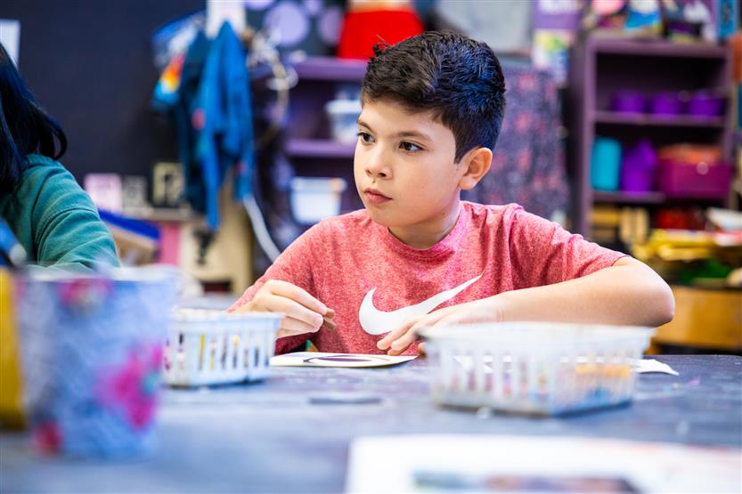 Students in an art class using oil pastels